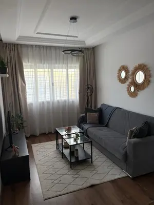 a living room with a couch and a table at The green stay in Rabat