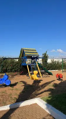 a playground with a slide in a park at Spacious beach escape villa with pool & play areas in Mansouria