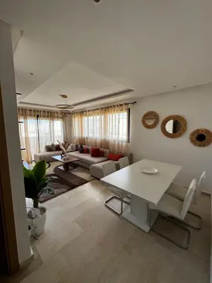 a living room with a white table and a couch at Murcia in Rabat
