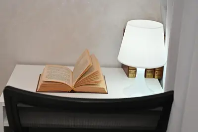 an open book on a table with a lamp and a light at Modern Luxury Apartment - Ground Floor in Rabat