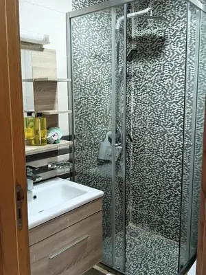 a bathroom with a shower and a sink at Palm Pool View Apartment - Bouznika in Bouznika