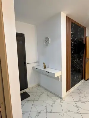 a room with a white counter and a refrigerator at Charming appartement next to the airport in Deroua
