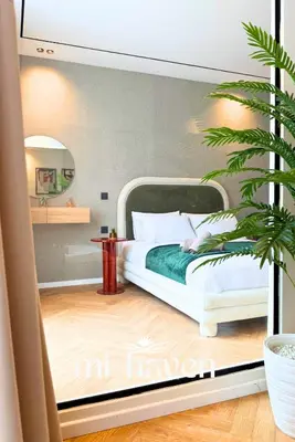 a bedroom with a white bed and a plant at hamy - 1br - Downtown Casablanca in Casablanca