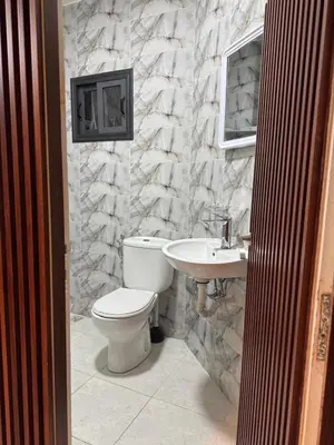 a bathroom with a toilet and a sink at Fatine