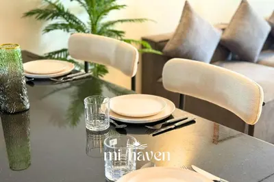 a dining table with plates and glasses on it at Hamma - 1 BR - Premium condo in Casablanca