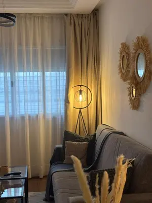 a living room with a couch and a mirror at The Green homestay in Rabat