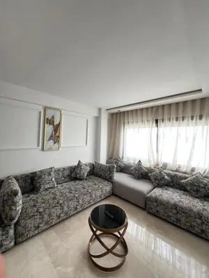 a living room with a couch and a coffee table at L'osmo - 1 BR - 2m from CFC in Casablanca