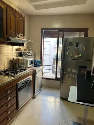 a kitchen with a stainless steel refrigerator and a window at Casablanca ANFA Apartment in Casablanca