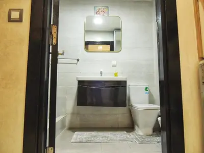 a bathroom with a sink and a toilet and a mirror at Appart de luxe, Confort et Emplacement, Corniche STAY MEMORIES in Mohammedia