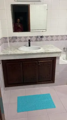 a bathroom with a sink and a person in a mirror at Big Villa In Rabat in Rabat