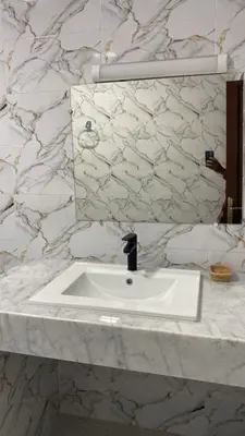 a bathroom with a white sink and a mirror at Big Villa In Rabat in Rabat