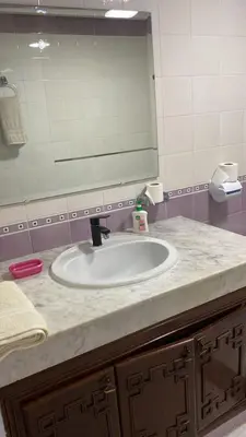 a bathroom sink with a large mirror above it at Big Villa In Rabat in Rabat