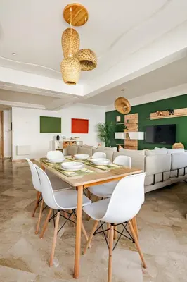 a dining room with a table and white chairs at Spacious, 2 BDR, Balcony, AC, Parking, Fiber Optic - Agdal in Rabat