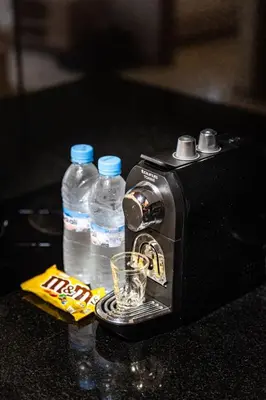 a toaster and two bottles of water on a counter at B-living Luxury studio Maarif palmier in Casablanca