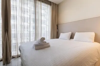 a bedroom with a bed with a towel on it at B-living Luxury studio Maarif palmier in Casablanca
