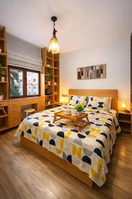 a bedroom with a large bed with a table on it at Spacious 3 Bedroom Apartment in Rabat Near Moulay El Hassan Stadium Malls and Embassies in Rabat
