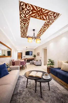 a living room with a couch and a table at Spacious 3 Bedroom Apartment in Rabat Near Moulay El Hassan Stadium Malls and Embassies in Rabat