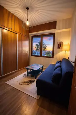 a living room with a blue couch and a table at Spacious 3 Bedroom Apartment in Rabat Near Moulay El Hassan Stadium Malls and Embassies in Rabat