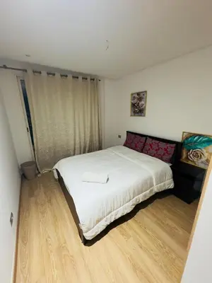 a bedroom with a large white bed in it at Granada in Rabat