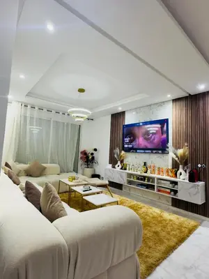 a living room with a couch and a tv at Granada in Rabat