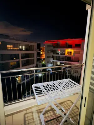 a white chair sitting on a balcony at night at Granada in Rabat