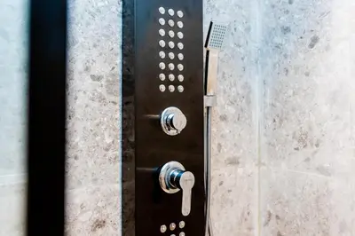 a shower with a glass shower door with a shower at Cosy Netflix & Amazing Sunset View in Casablanca