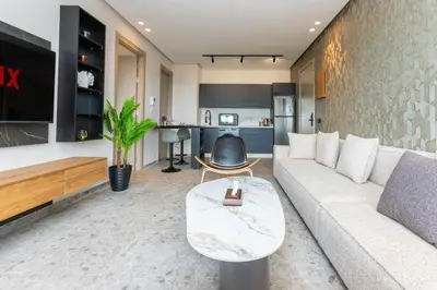 a living room with a white couch and a kitchen at Cosy Netflix & Amazing Sunset View in Casablanca