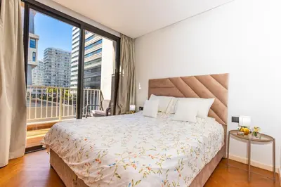 a bedroom with a large bed and a large window at Central Studio CFC I Gym I Pool in Casablanca