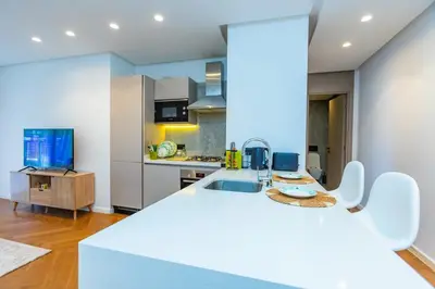 a kitchen with a white counter top in a room at Central Studio CFC I Gym I Pool in Casablanca