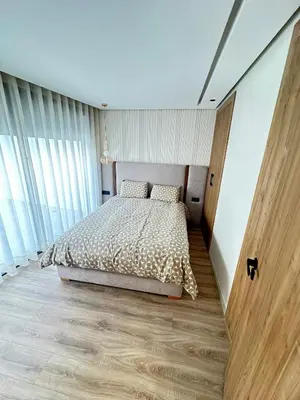a bedroom with a bed and a large window at France Ville 2 Appartement Meublé Premium avec Terrasse in Maarif
