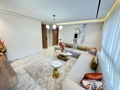 a living room with a couch and a table at France Ville 2 Appartement Meublé Premium avec Terrasse in Maarif