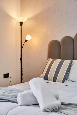 a bedroom with a bed with two pillows and a lamp at Luxueux Appartement Sécurisé in Casablanca