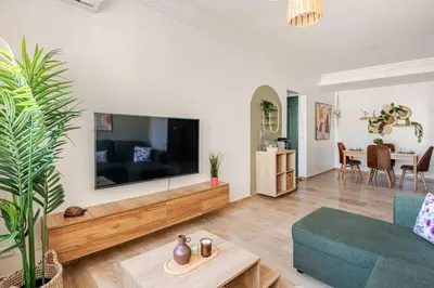 a living room with a large flat screen tv on a wall at Modern, 1 BDR, AC, Parking, Elevator, Fiber Optic - Agdal in Rabat