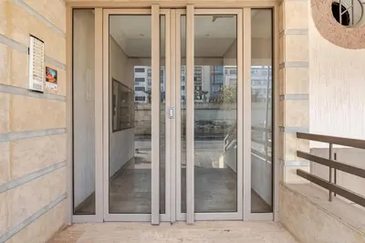 an entrance to a building with glass doors at Modern, 1 BDR, AC, Parking, Elevator, Fiber Optic - Agdal in Rabat
