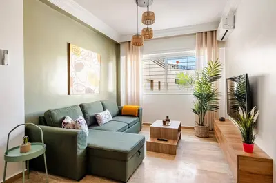 a living room with a couch and a table at Modern, 1 BDR, AC, Parking, Elevator, Fiber Optic - Agdal in Rabat
