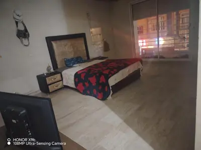 a bedroom with a bed and a dresser and a tv at Appartement 2mars in Casablanca