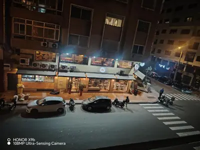 two cars parked in front of a store at night at Appartement 2 mars in Casablanca