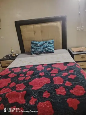 a bedroom with a bed with a black and red blanket at Appartement 2 mars in Casablanca