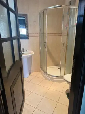 a bathroom with a shower and a toilet and a sink at VILLA BOUSKOURA Casablanca in Casablanca