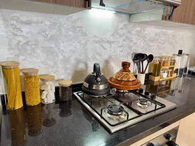 a kitchen counter top with a stove top oven at Appartement de Luxe près du CFC et de l Hôpital Cheikh Khalifa in Casablanca