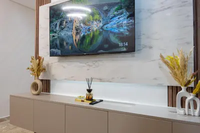a living room with a tv on the wall at Magnificent apartment 2 in Casablanca