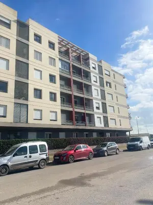 a large building with cars parked in front of it at Taj collection 1 in Casablanca