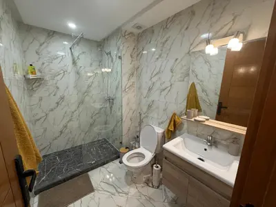 a bathroom with a toilet and a sink and a shower at Sanctuaire Soleil & Luxe Casablanca in Casablanca