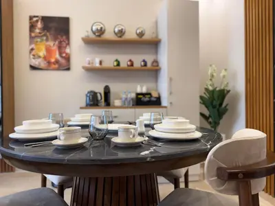 a table with plates and glasses on top of it at Sanctuaire Soleil & Luxe Casablanca in Casablanca