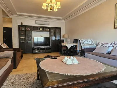 a living room with a couch and a table at Appartement au centre-ville, calme et lumineux in Casablanca