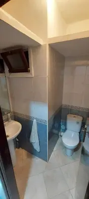 a bathroom with a toilet and a sink at Appartement idéal pour familles in Temara