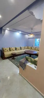 a living room with a couch and a table at Appartement idéal pour familles in Temara