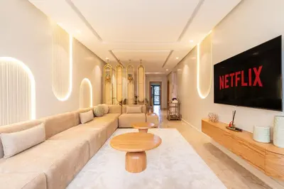 a living room with a couch and a tv at Luxurious 2BR 2BA For Families and groups in Casablanca
