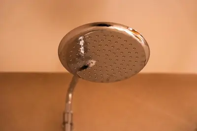 a silver shower head hanging from a wall at Luxurious 2BR 2BA For Families and groups in Casablanca