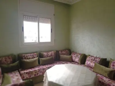 a living room with a couch and a window at Joli appartement bien équipé-Casablanca in Casablanca